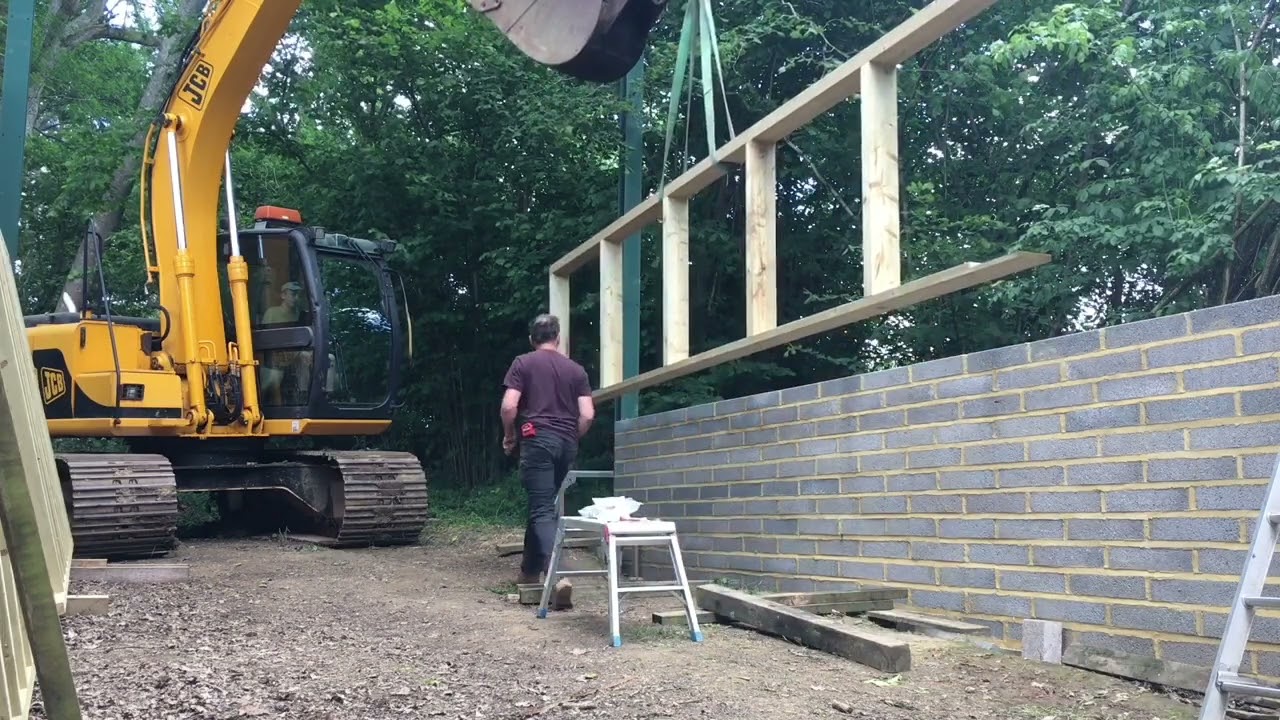 JCB JS130 lifting wooden frames
