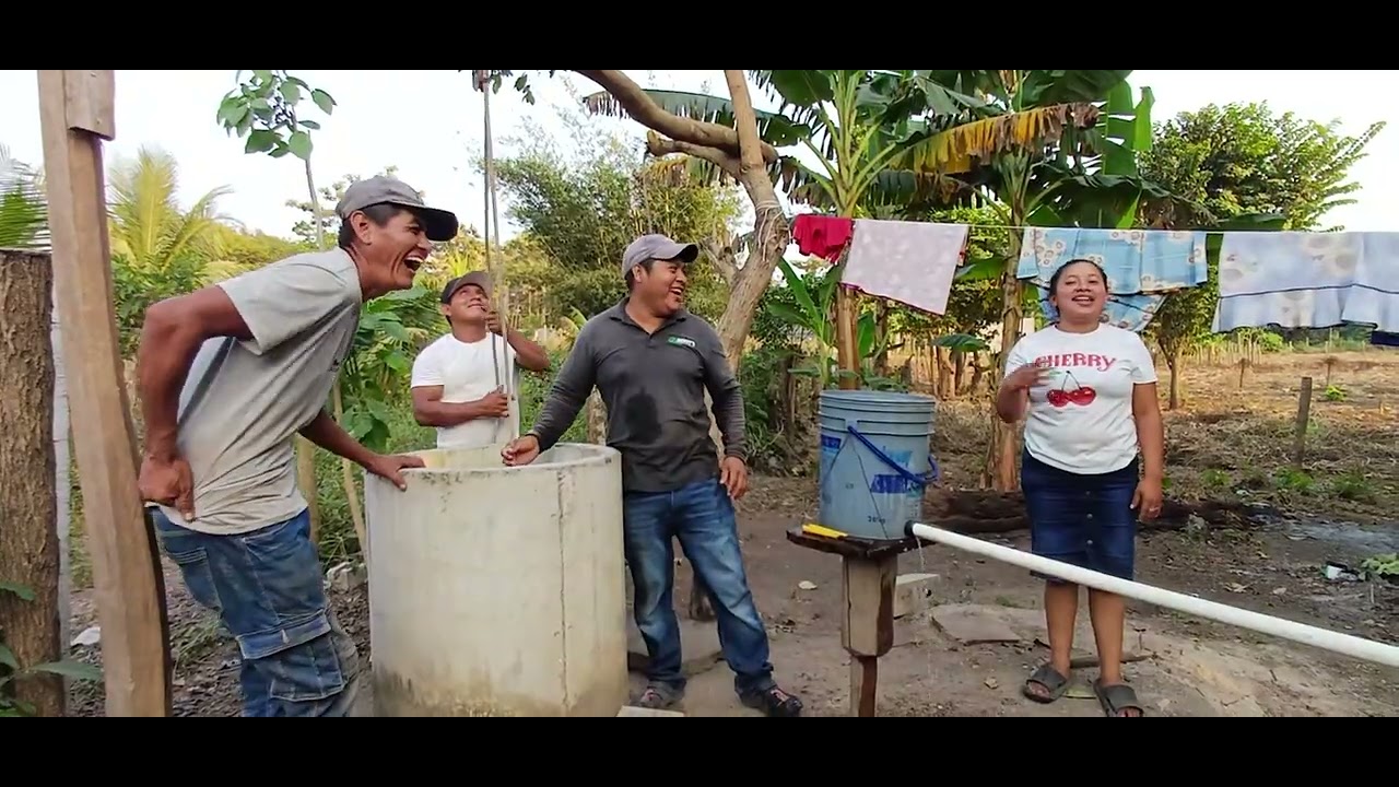 Cushin y juana feliz por el apoyo ayudándolos a sacar agua del poso. 