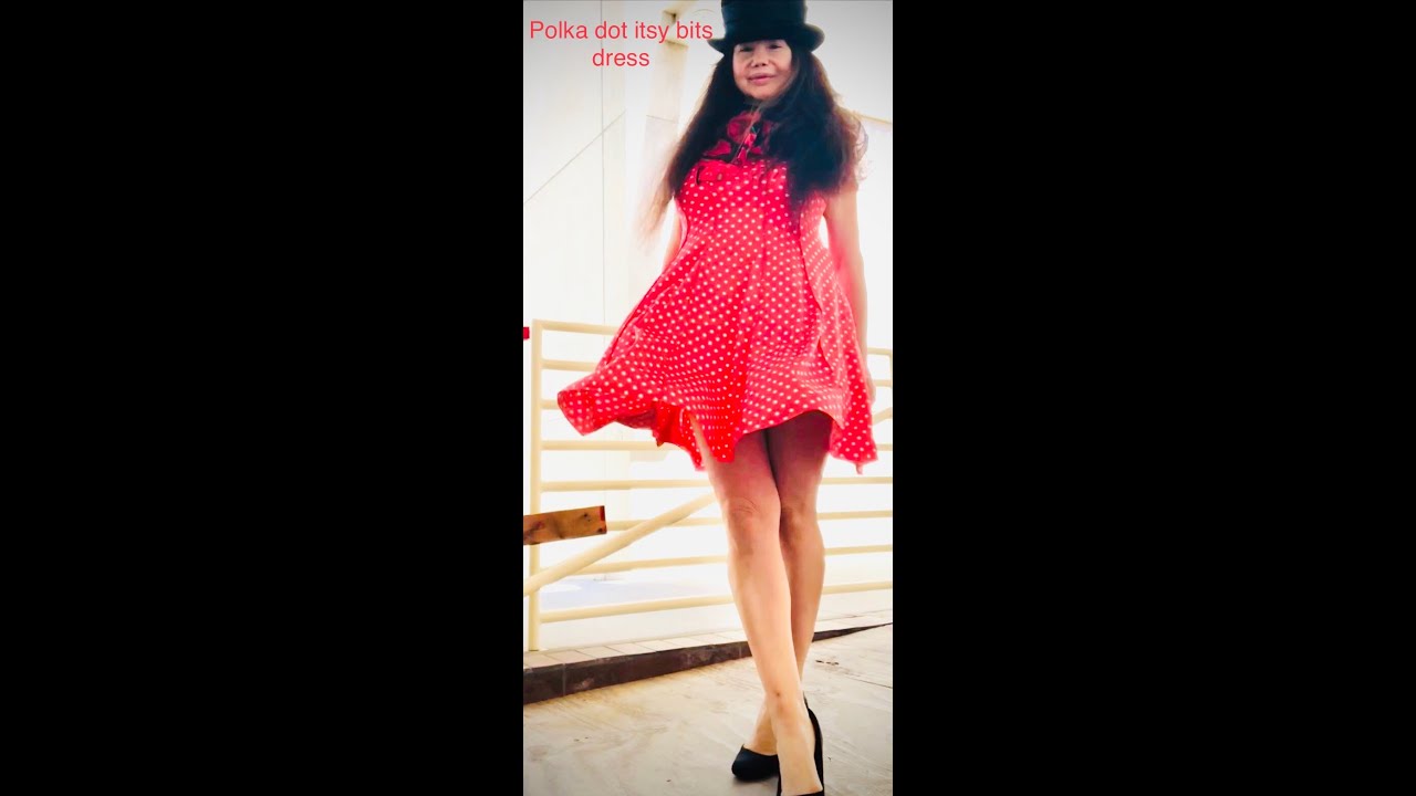Windy day with polka dot itsy bitsy orange dress