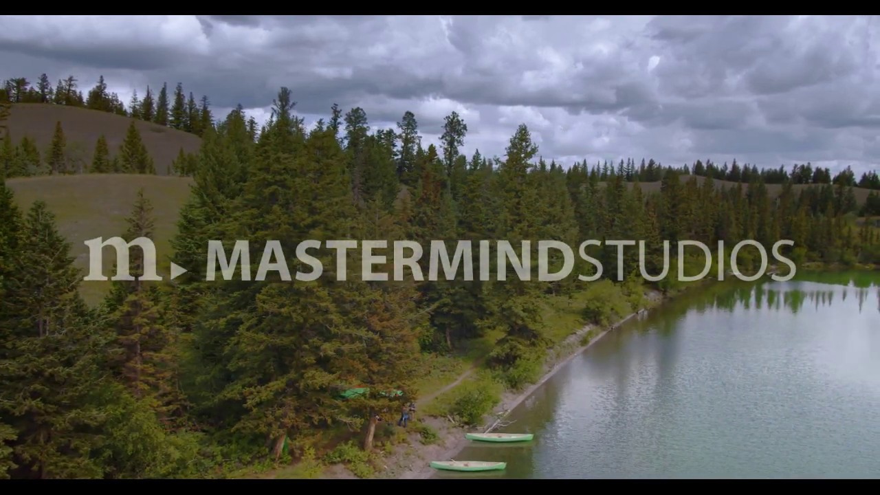 Aerial drone view revealing shore with canoes at Big Bar Lake, BC