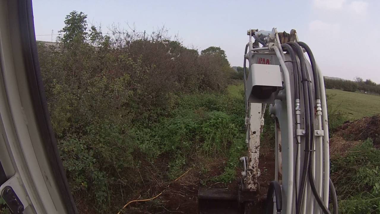 Making a path around the muck heap  Takeuchi TB225