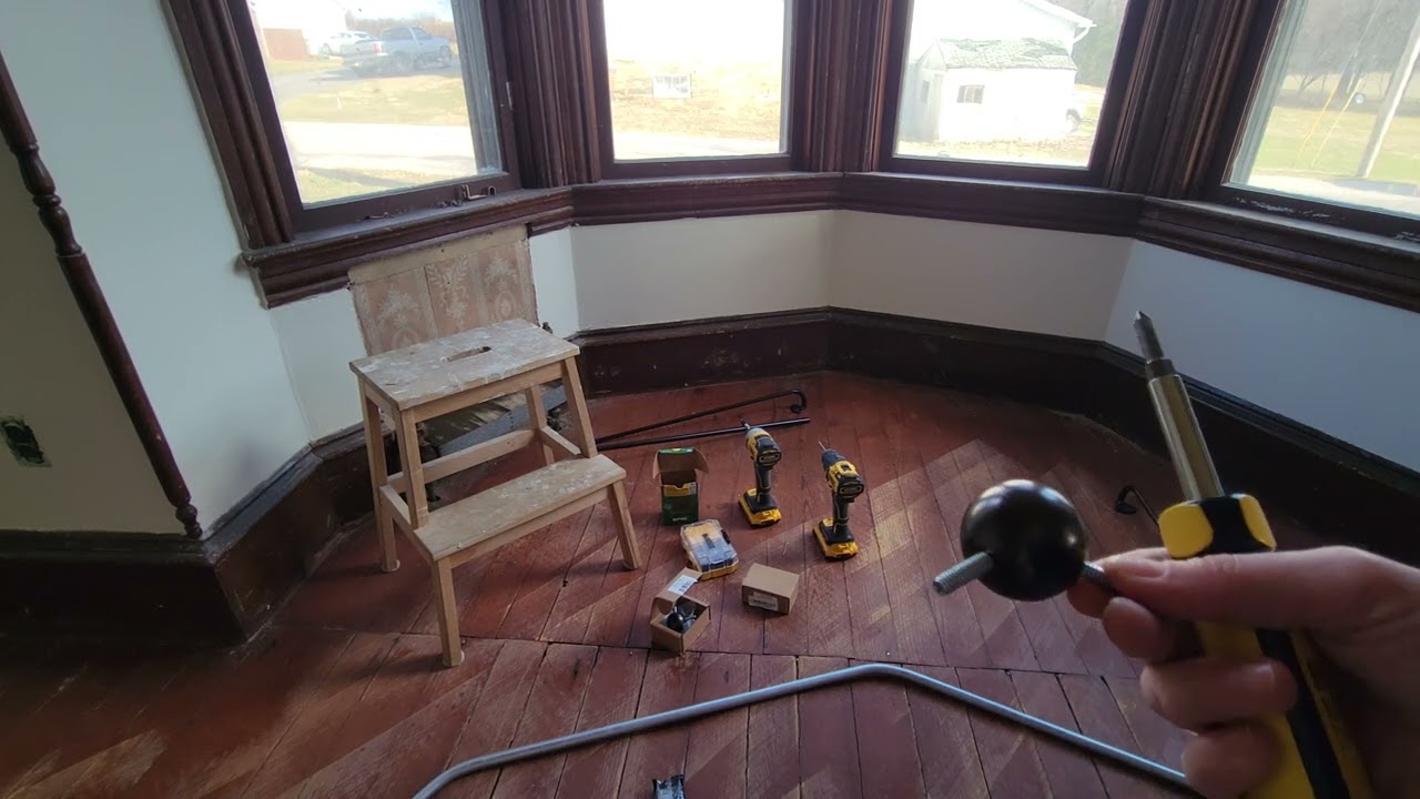 How to Easily Put up Angle Curtain Rods (bay window curtain rod)
