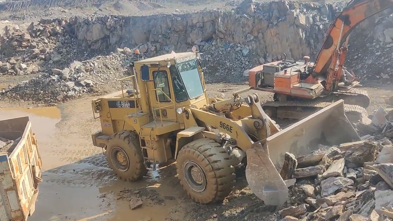 Powerful Caterpillar Loader Loading Giant Stones in Mountain Quarry