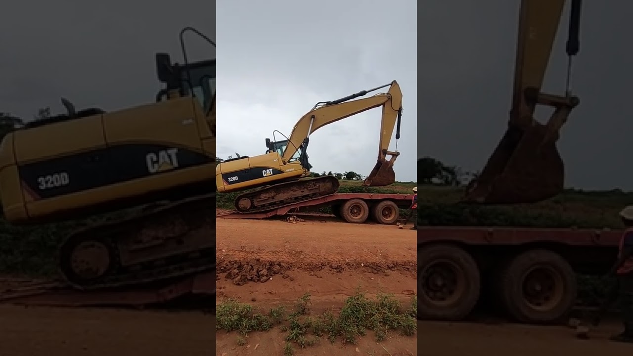 CAT excavator loading in low bed