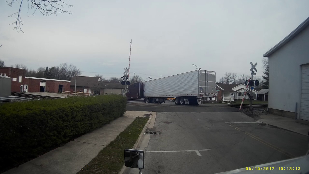 Crossing barrier comes down on trucker who breaks it and flees the scene