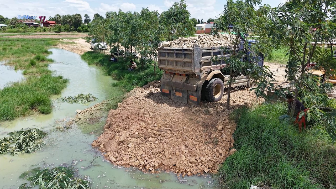 Nicely Filling Up Land Project! Good Technique Of Bulldozer Push Stone Into Flood Area With Trucks