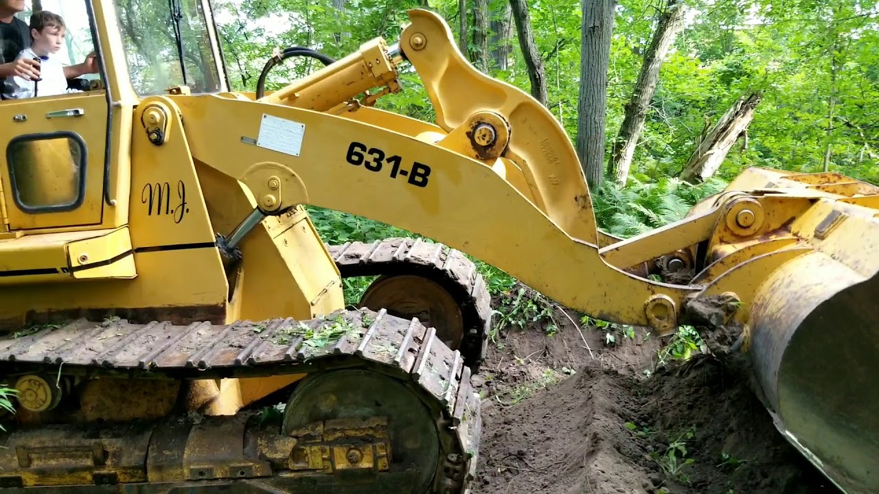 Liebherr 631-B track loader flattening dirtbike jump