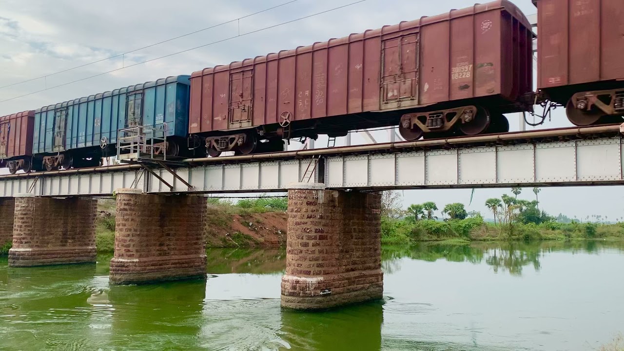 Goods Train passing over Buckingham Canal bridge near Angalakuduru, Tenali.