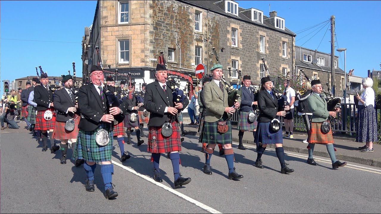 March of the Stewards led by massed pipers to the 2021 Argyllshire Gathering Oban Highland Games