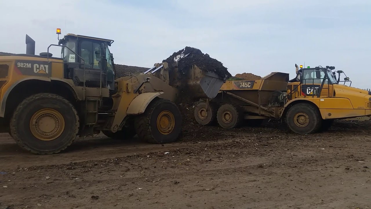 Cat 730c Articulated Dump Truck being loaded by Caterpillar 982m Loading Shovel Machine