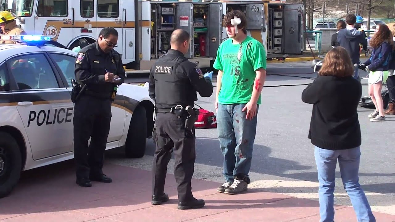 Police question senior Alex Hobby during Every 15 Minutes simulated car crash