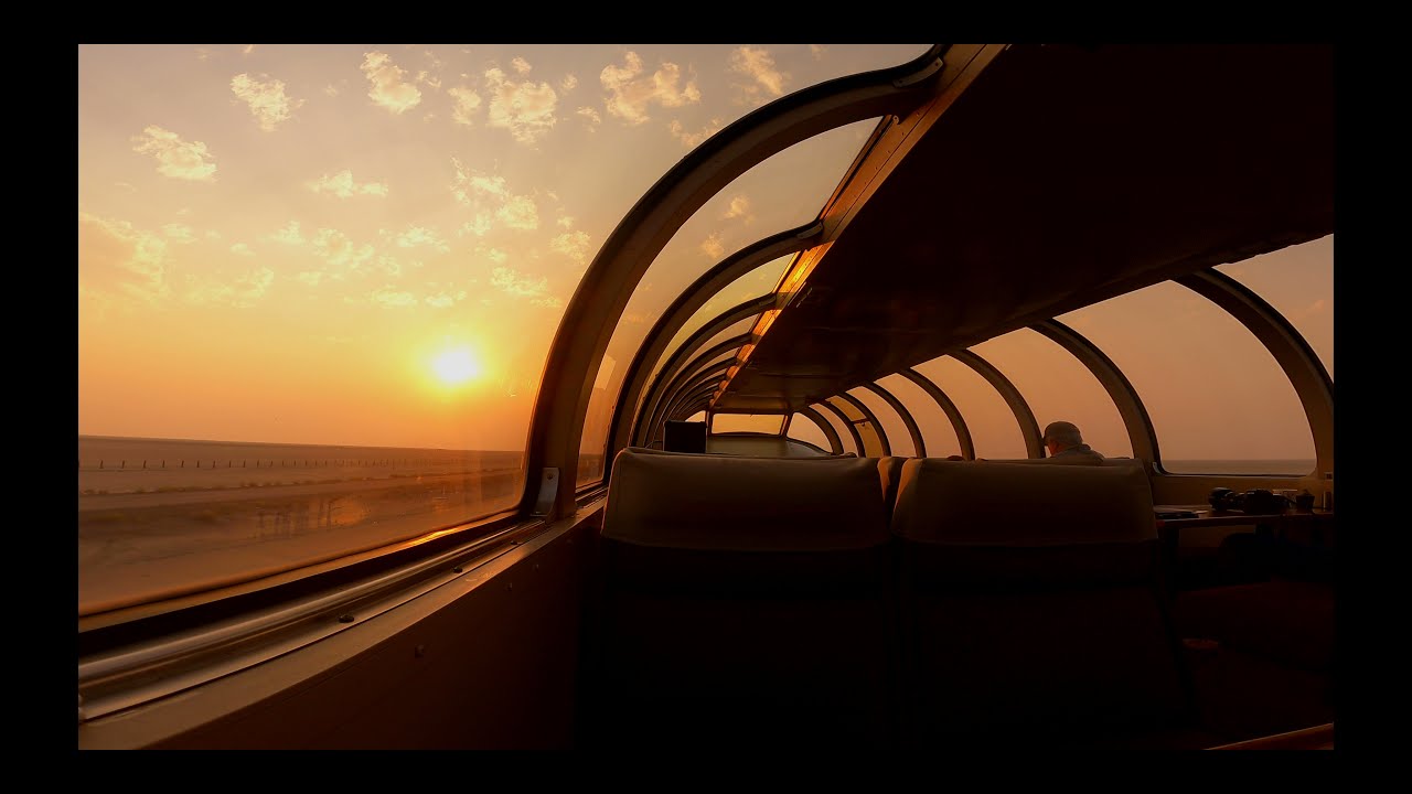 Private rail cars behind Amtrak California Zephyr dome car sunrise and sunset Utah salt flats