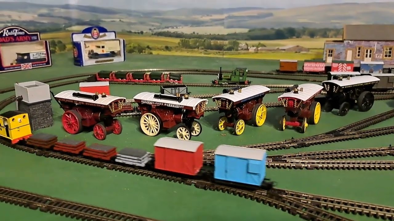 Bachmann Yellow Rheneas pulling 1 brown, 2 red, 1 grey slate wagons, red box van and blue brakvan 