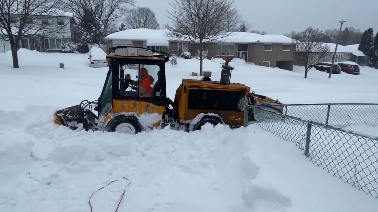 Snow Plow Clearing a Snowy Sidewalk