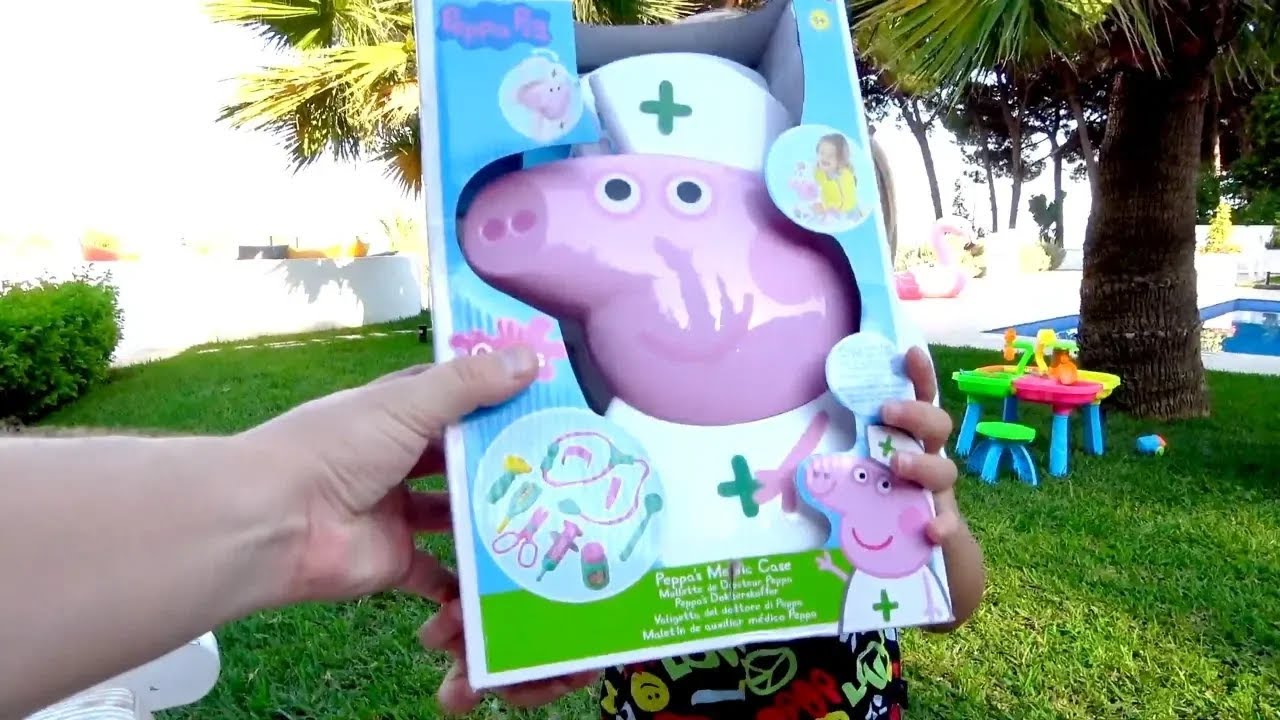 Сhild pretends to play with a set of " Dr. pig"