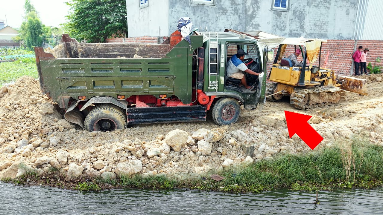 Wow! Old Bulldozer but still strong in pushing soil and helping dump trucks