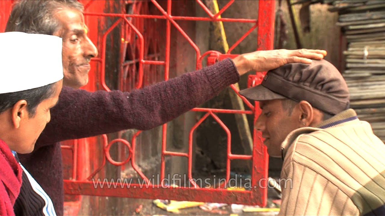 Hindu priest tying a sacred thread and blessing devotees