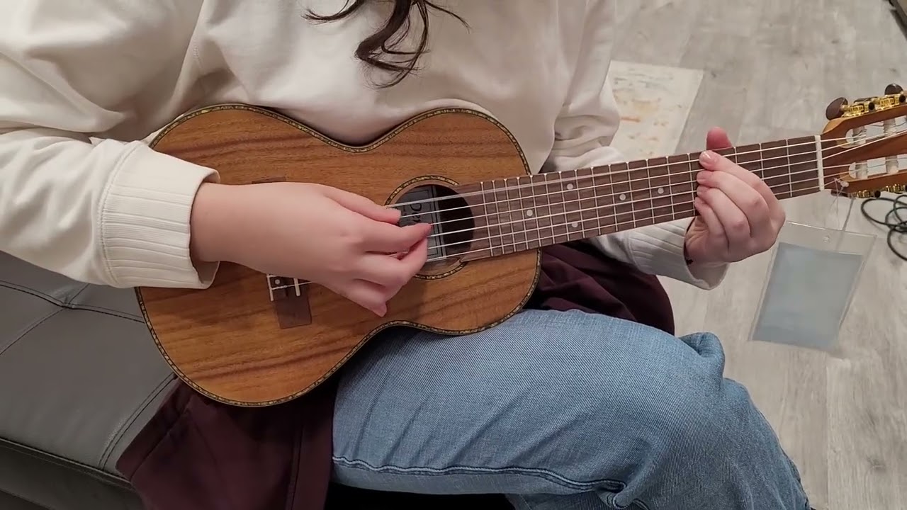 laufey on a mini guitar