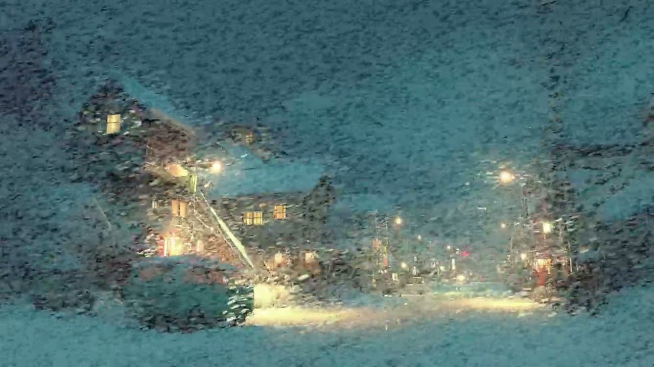 Quiet Snowy Village Streets Glowing Softly Under a Gentle Endless Winter Blizzard Night Time