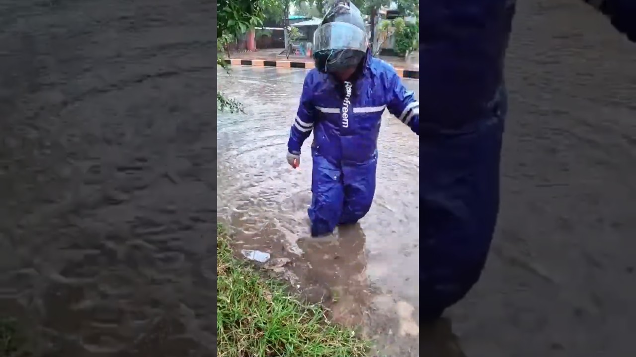 Clearing flooded streets after heavy rain removing debris and grass from gutters