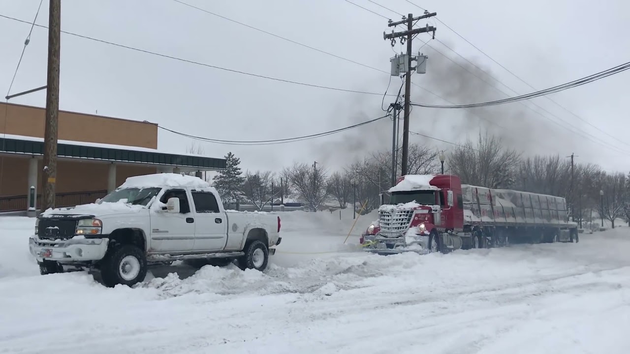 Duramax pulls out stuck semi in the snow!