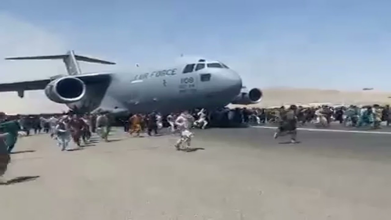 CHAOTIC SCENE: People chase after a plane on a runway at Kabul airport