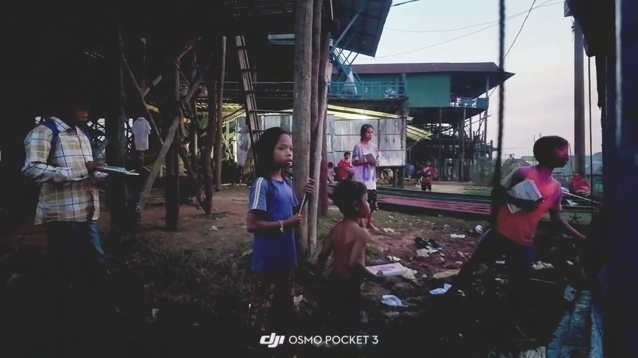 Providing some writing materials to the kids at Kampong Pluk, Tonle Sap, Cambodia