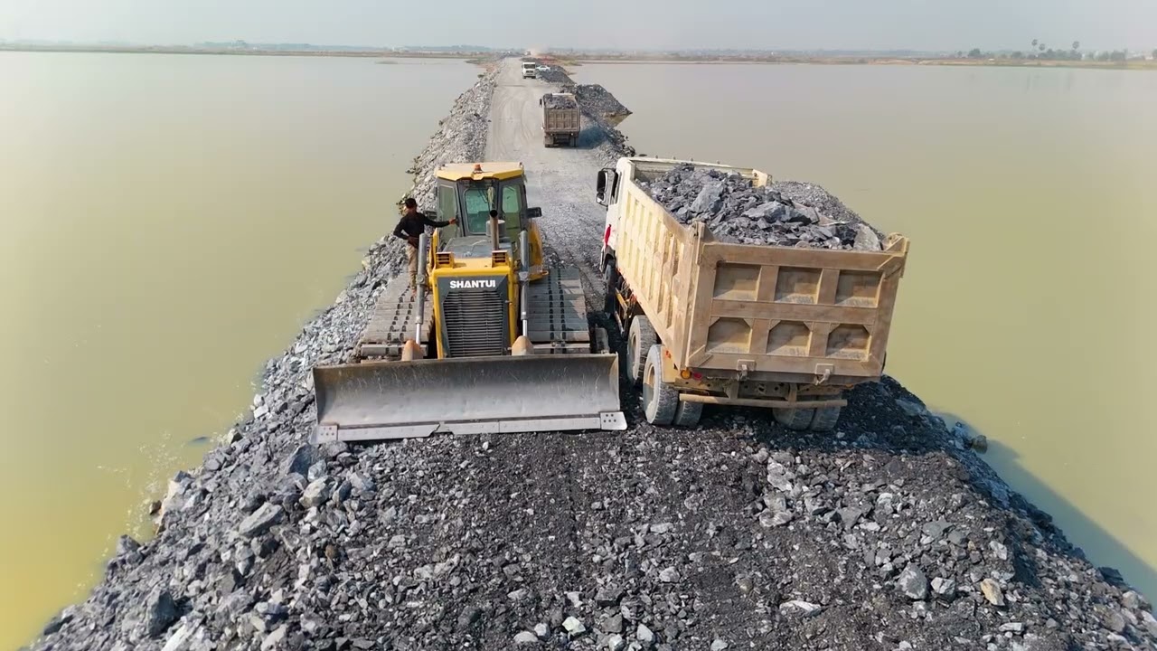 EP04,Fantastic road project Use a truck,wheel loaderand a Dozer Shantui to dump rocks into a sizabl