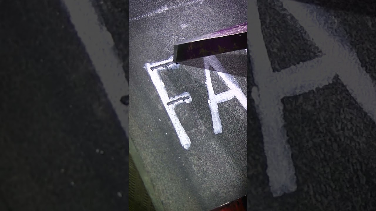 Hammer and chisel stone lettering in slate
