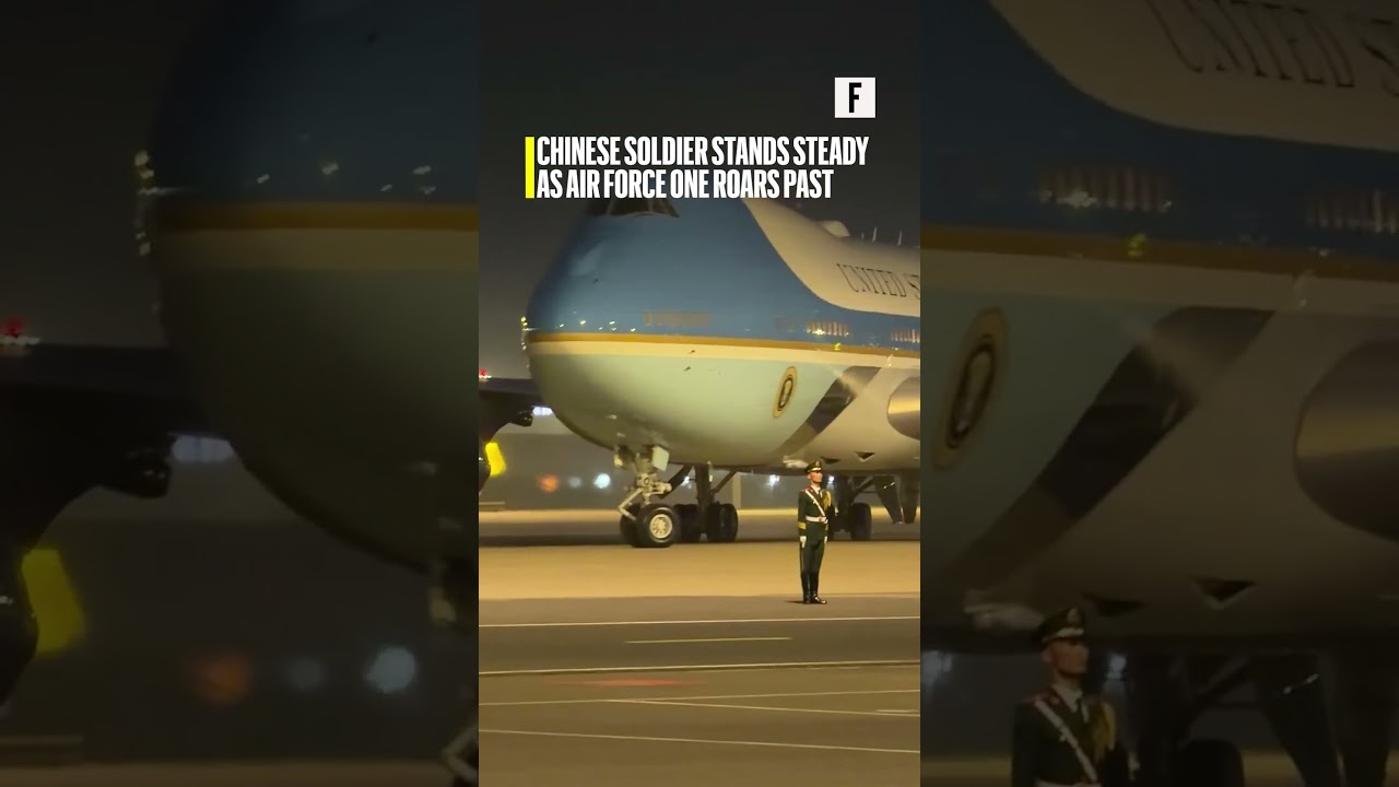 Chinese soldier stands steady as Air Force One roars past