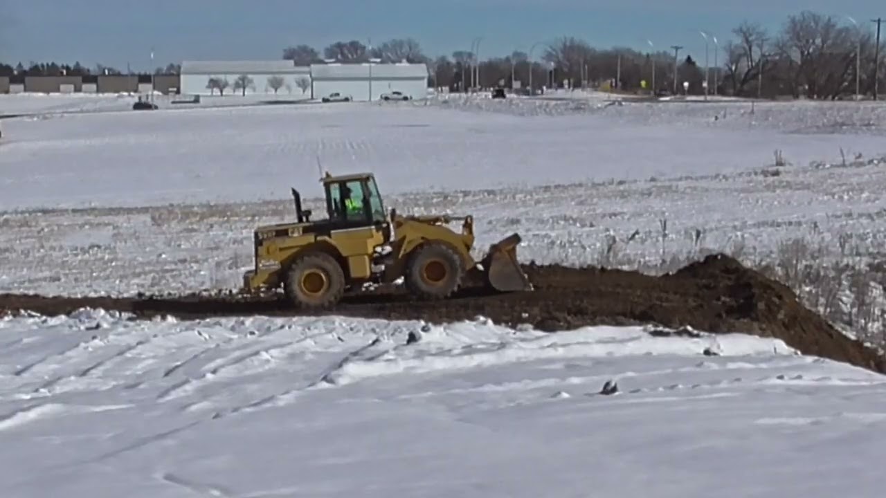 SPREADING FROZEN DIRT