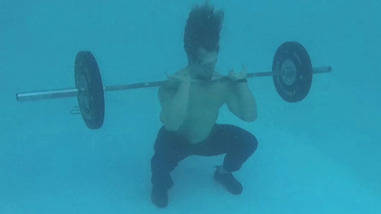 Muscle Man Lifts Weights Underwater