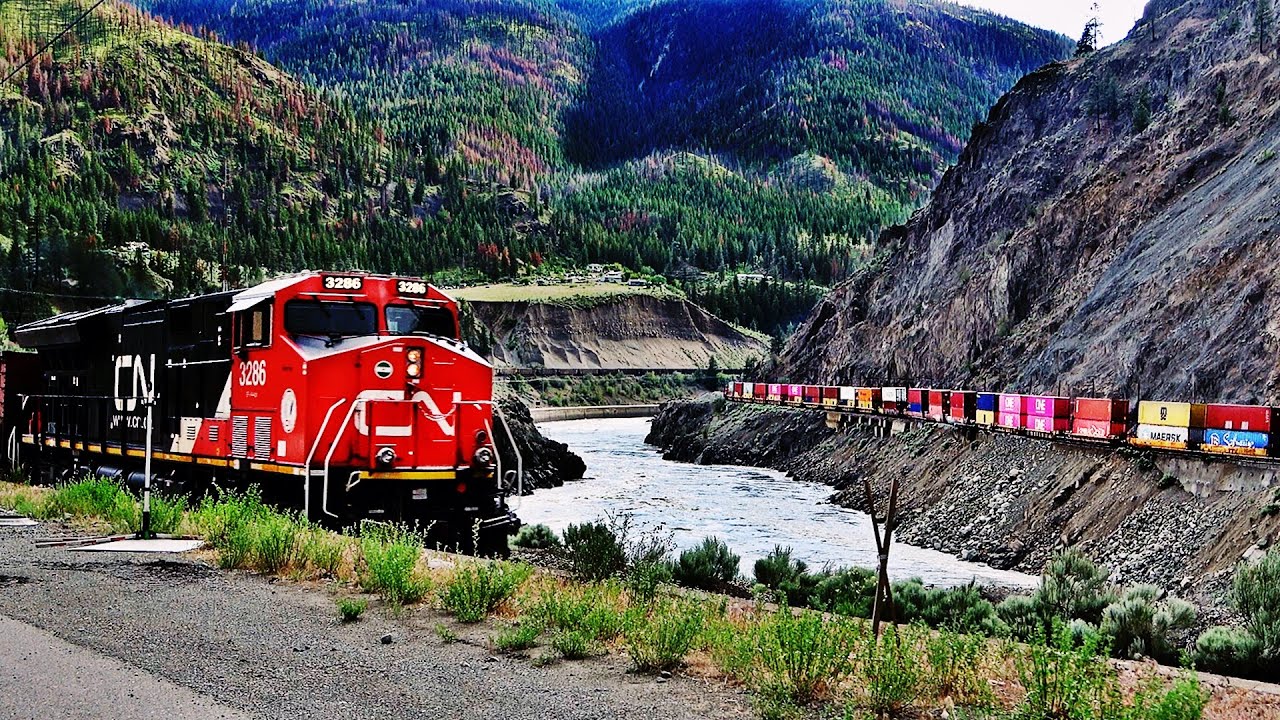 HUGE TRAINS MEET THRU TUNNELS & SHEDS IN THE THOMPSON CANYON - CANADA