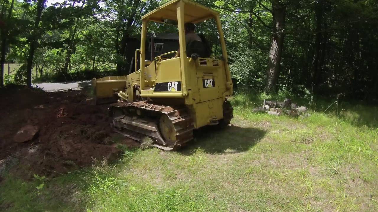 cat d4c dozer spreading dirt