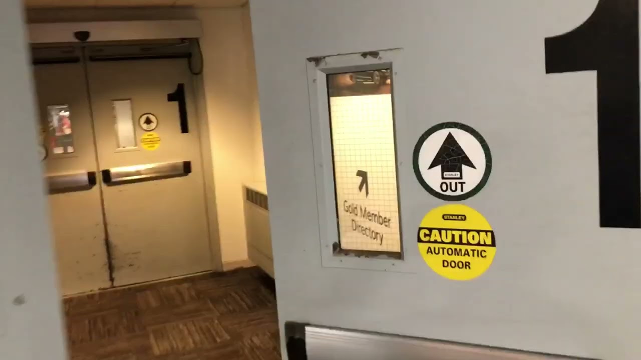 Older Stanley automatic swing doors Nabco sliding door at Milwaukee Michael airport in Wisconsin