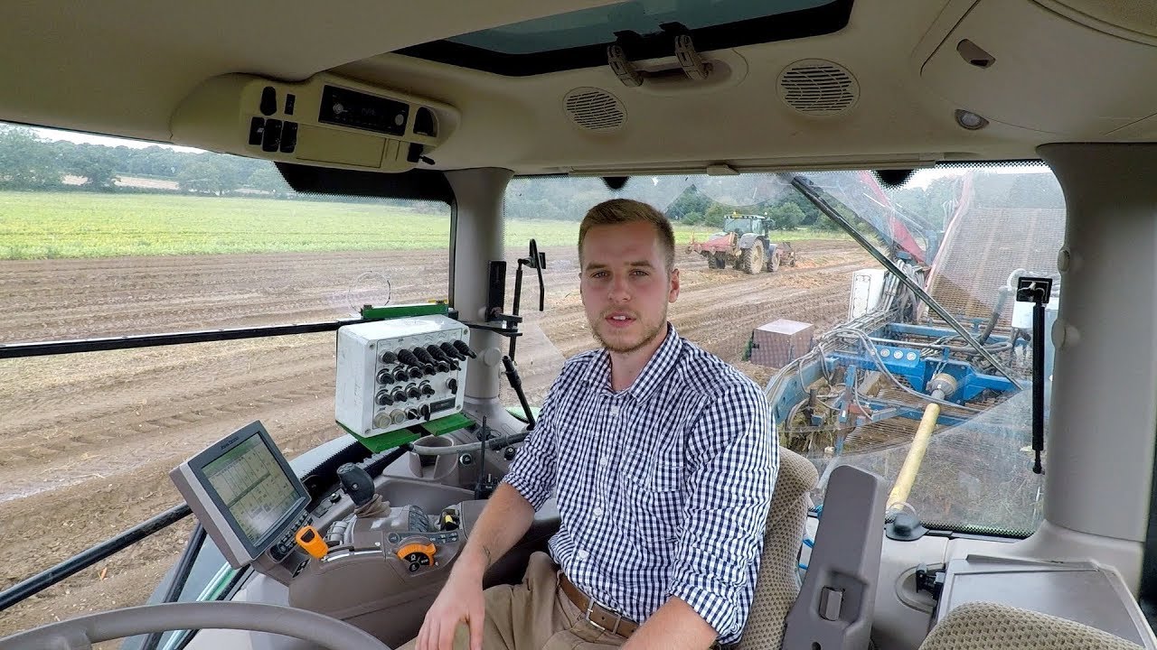 View from my tractor cab operating farm machinery to harvest carrots