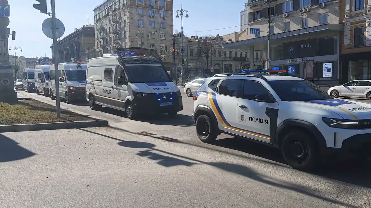 Kyiv riot police & bomb squad vehicles with red-blue lights responding
