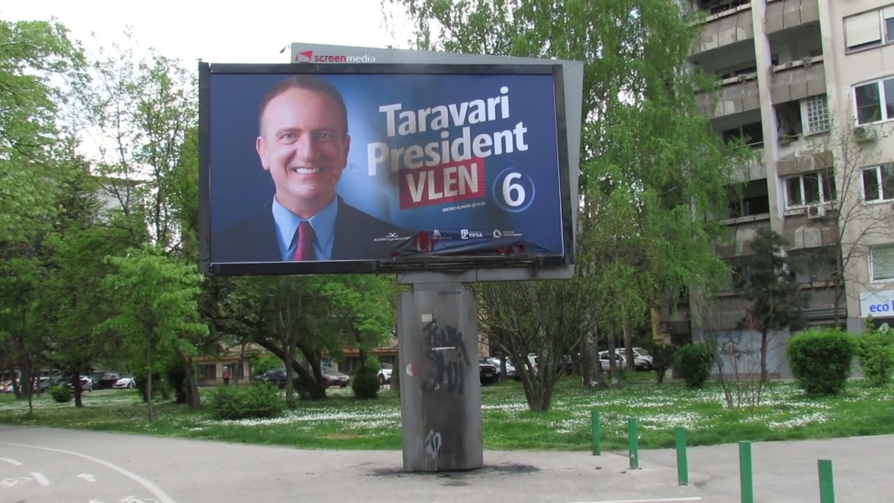 Shot: Damaged Billboard of Vlen's Candidate Arben Taravari