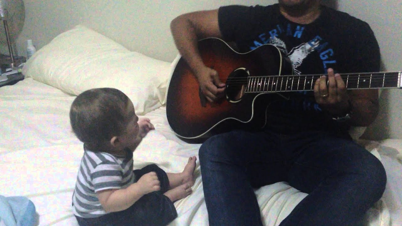 Baby laughing hysterically at guitar