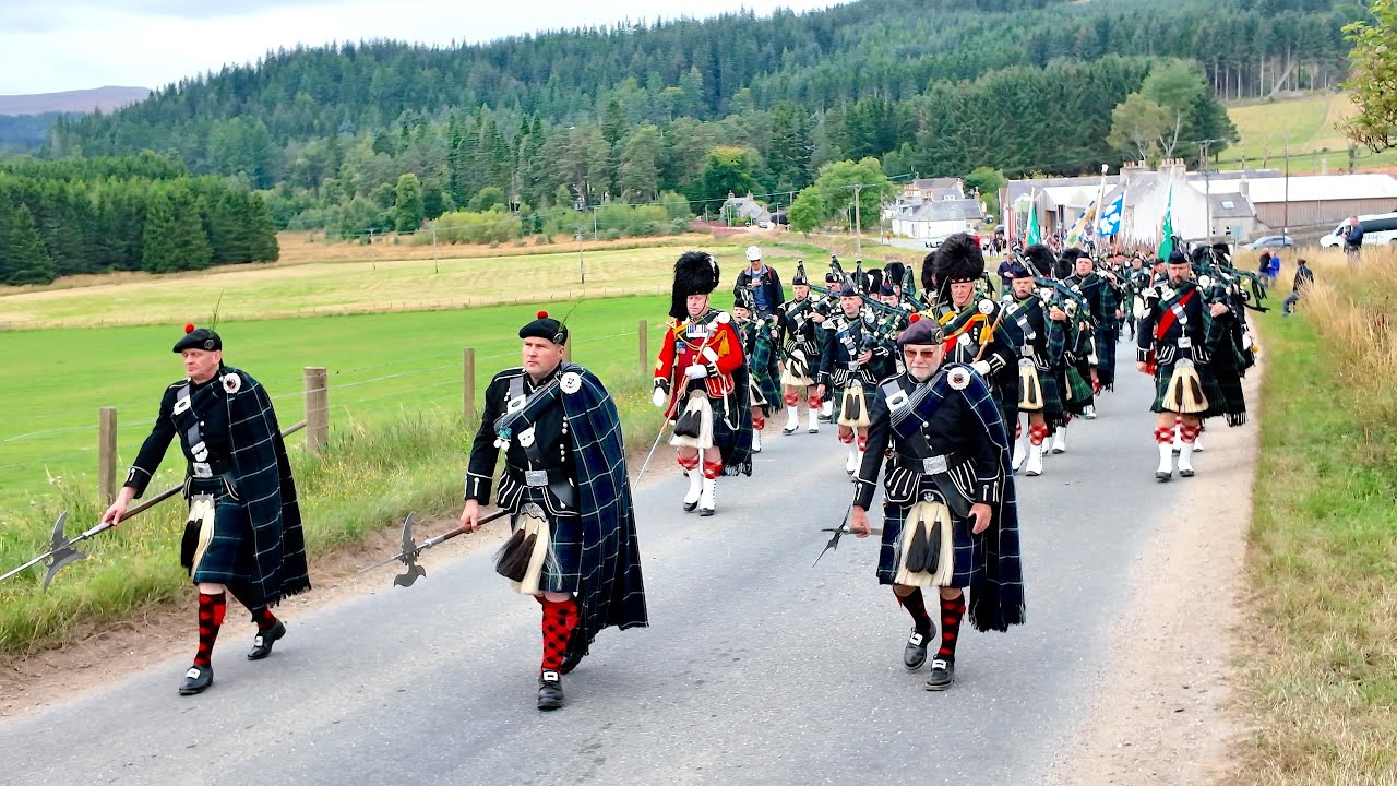 Drums echo as Lonach Highlanders march through Cairngorms during 2025 Lonach Gathering in Scotland