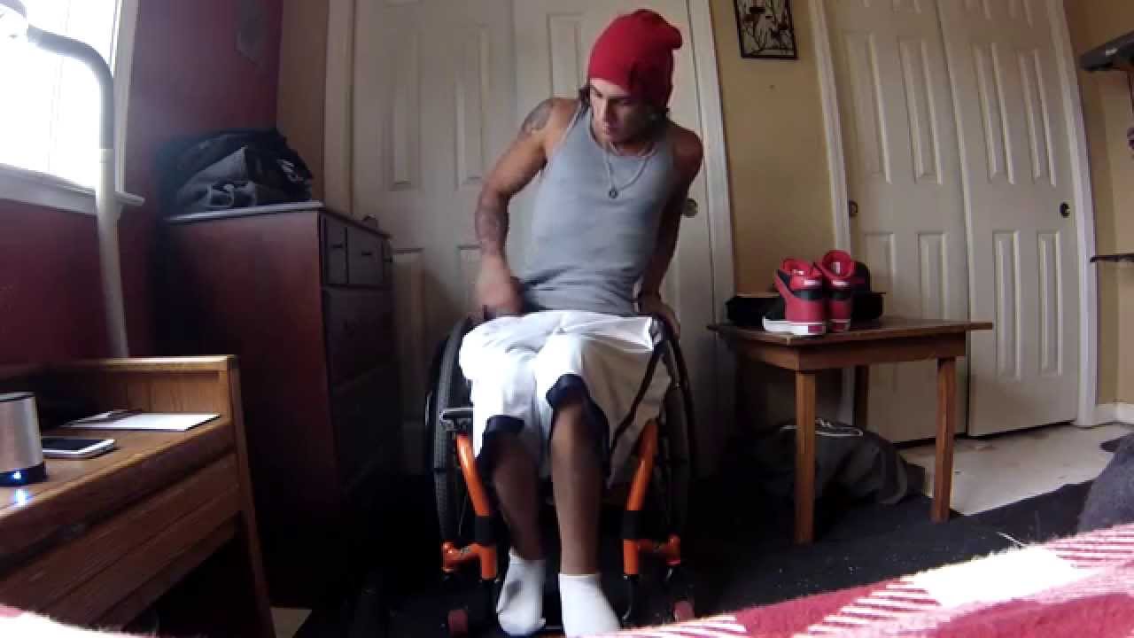 Paraplegic getting dressed in wheelchair