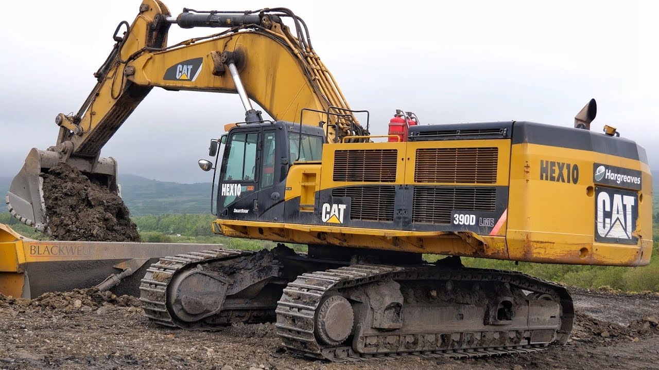 Cat 390D Excavator Loading Trucks.