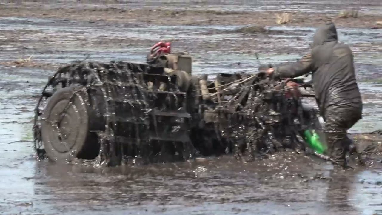 Place floating float wheels on the wheels of a tractor to clear the muddy land for rice cultivation 