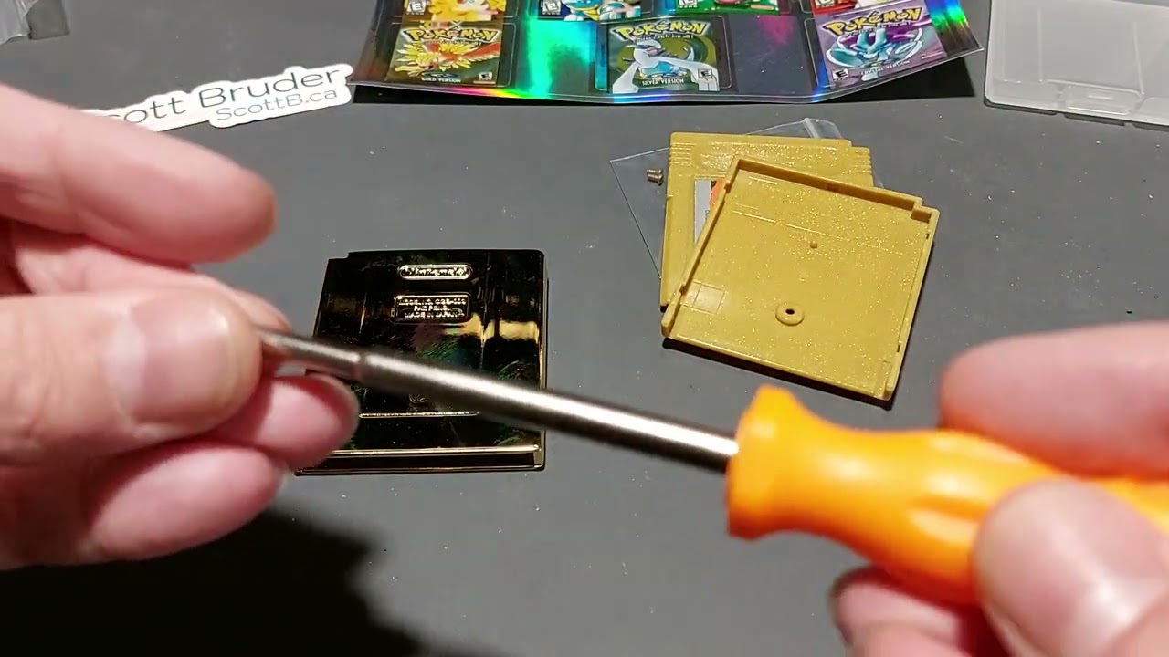 Pokemon Gold game in a damaged shell upgrade, a modern Pokemon Gold shell with a holographic sticker