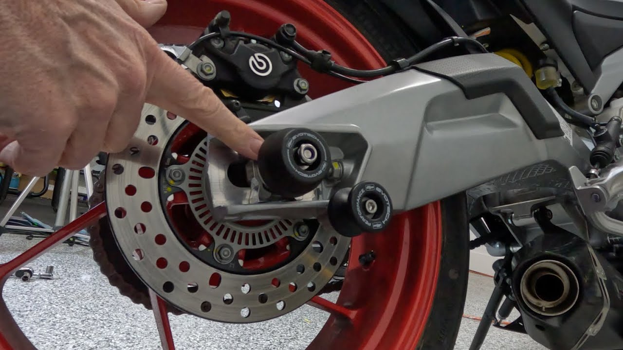 Evotech Axle Sliders  and Paddock Bobbins install on my Aprilia Tuono 660  Factory