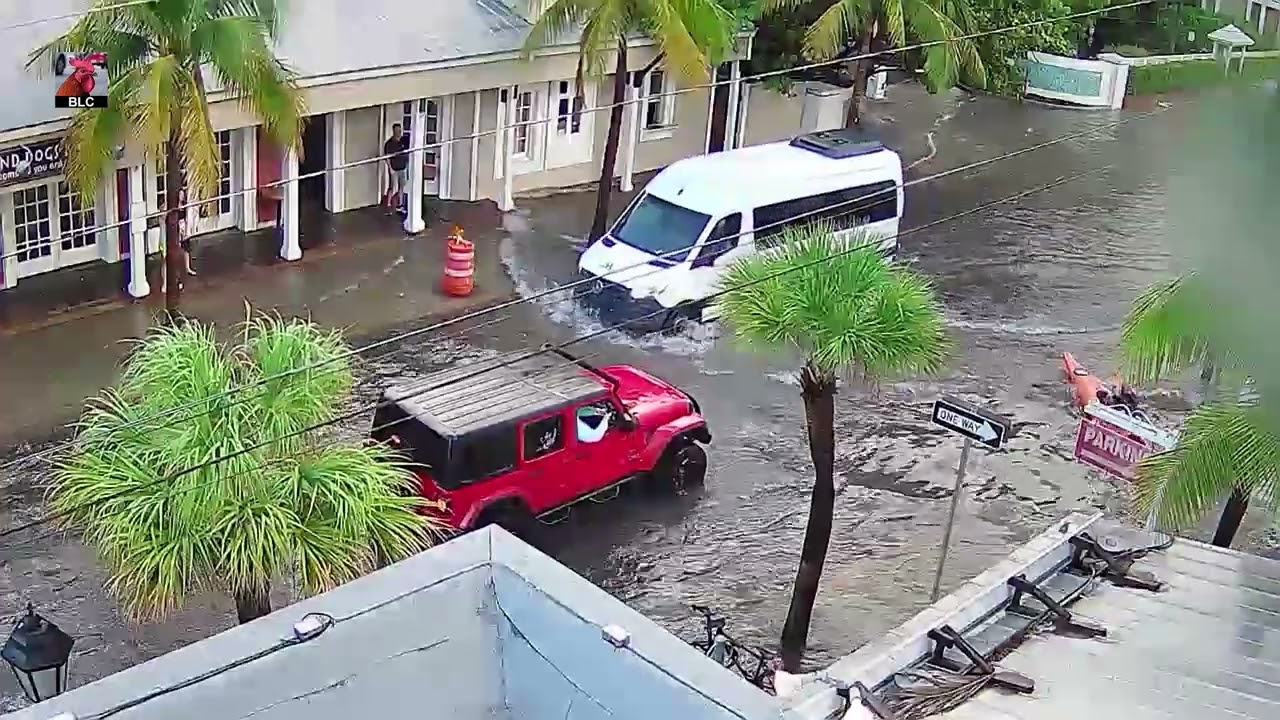 Kayaking and driving on flooded Front Street Key West Florida