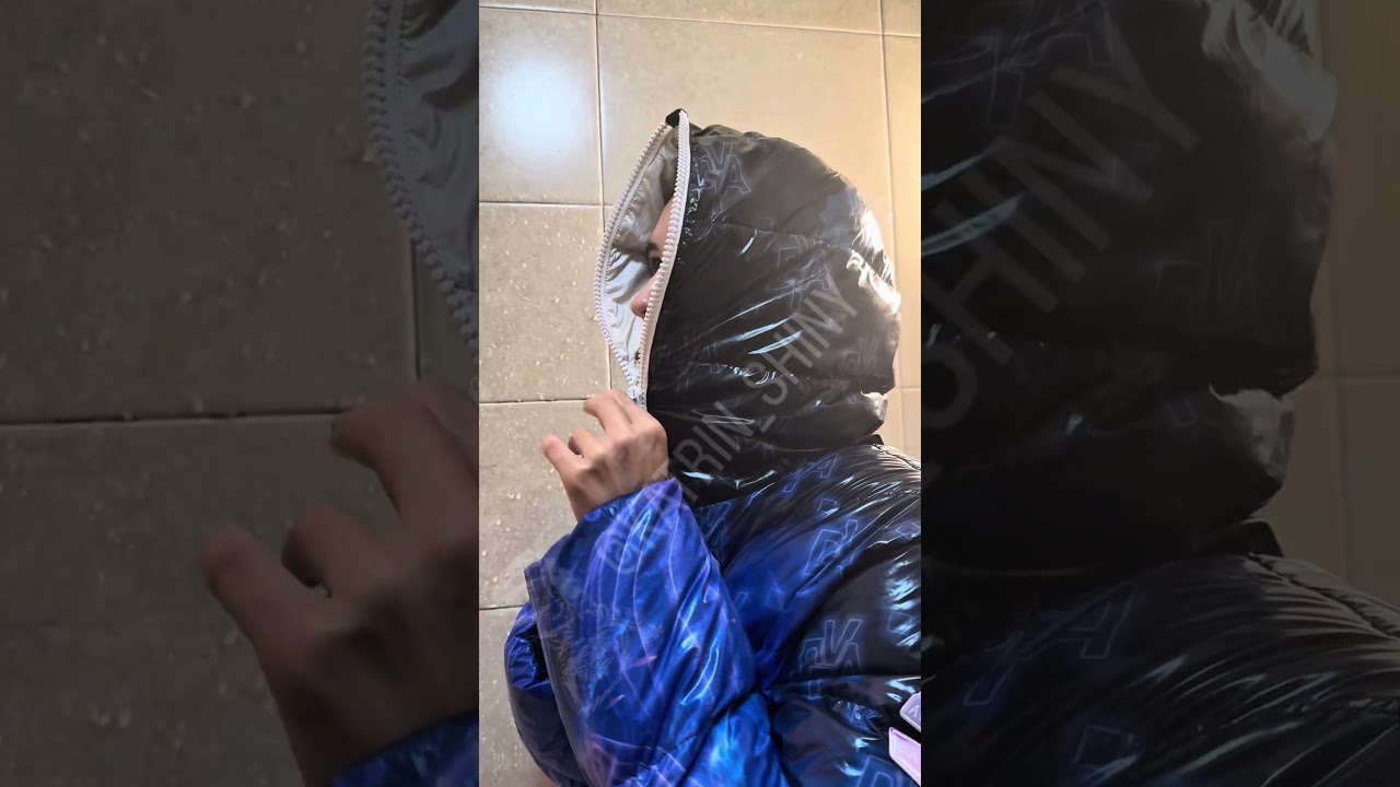 Shower clothed Beautiful Lady fully clothed in waterproof shiny puffy rain jacket hood fullzip
