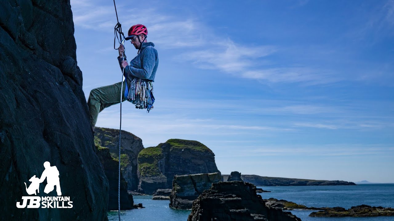 How to pass a knot when abseiling / rappelling and lowering - Climbing how to with a rescue slant...
