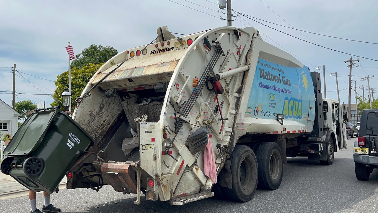 ACUA CCC McNeilus rear loader garbage truck with a fast crew on trash