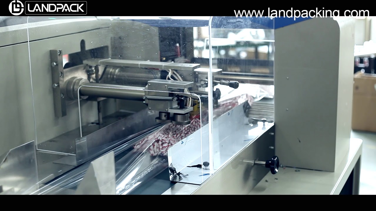pillow packing machine, horizontal packing machine, packaging system,